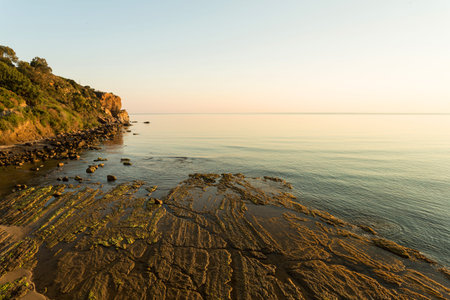 Volcanic rocky coast near the Sicilian town of Cefaluの写真素材