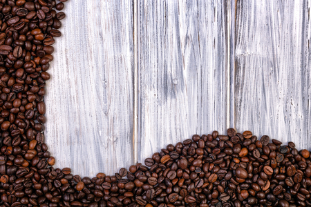 Coffee beans stacked  on the  white, wooden and old backgroundの写真素材