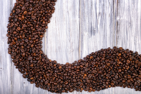 Coffee beans stacked  on the  white, wooden and old backgroundの写真素材