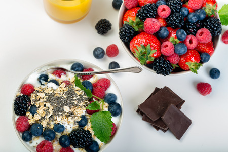 Bowl of berries  on a bright background. Healthy breakfastの写真素材