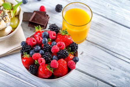 Bowl of fresh fruit. Blackberries; raspberries; blueberries on a bowl. Healthy breakfast. Vegetarian organic meal.の写真素材