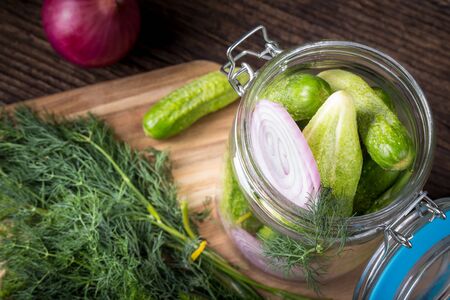 Preservation cucumber with dill and onion. Branch seasoning aromatic spice and jar. Selective focus.の写真素材