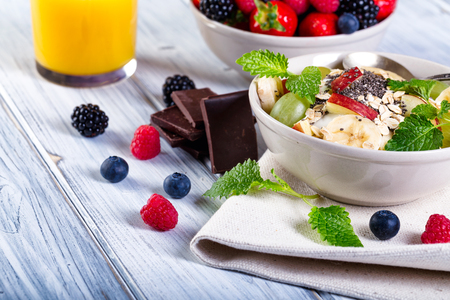 Bowl of fresh fruit. Blackberries; raspberries; blueberries on a bowl. Healthy breakfast. Vegetarian organic meal.の写真素材