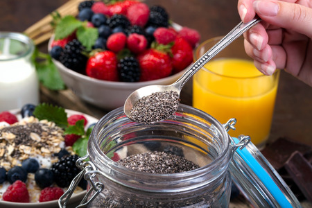 Spoon of chia. Bowl with berries. Selective focus.の写真素材
