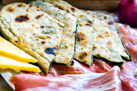 Croatian typical traditional food, soparnik and prosciutto and cheese.の写真素材