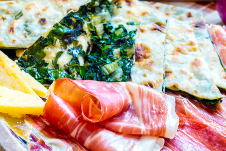 Croatian typical traditional food, soparnik and prosciutto and cheese.の写真素材