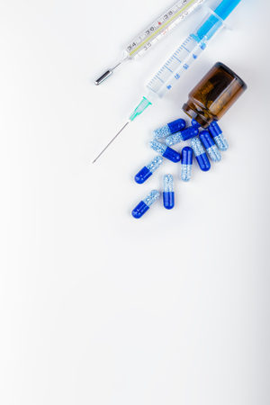 Bunch of blue pills with glass ampoules. Medical tools.Pharmaceutical industry.の写真素材