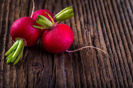 Fresh radish on old vintage wooden table. Fresh vegetable.の写真素材