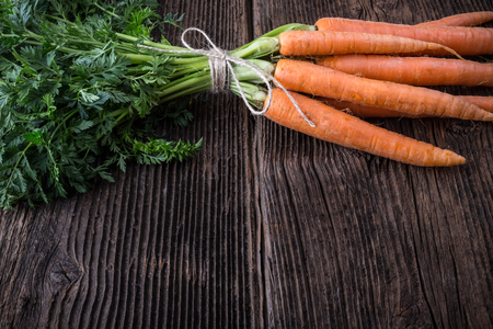 Fresh young bunch of carrots and leaves. Suitable for vegetarians and vegans.の写真素材