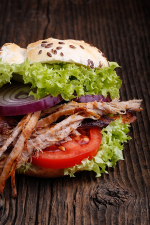 Pulled pork burger with coleslaw tomato, onion and fresh bread. Meat burger.の写真素材