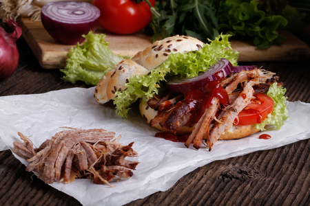 Pulled pork burger with coleslaw tomato, onion and fresh bread. Meat burger.の写真素材