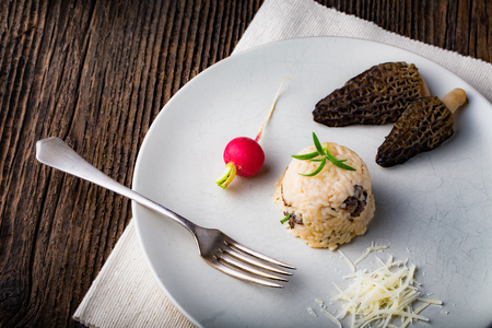 Delicious mushroom risotto with parmesan cheese. Risotto with morchella fungi.の写真素材