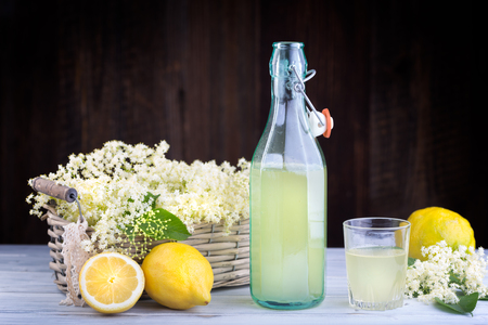 Fresh syrup from nigra sambucus with yellow lemons in glass bottleの写真素材