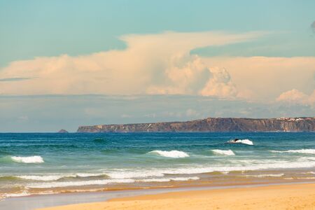 Nice open beach wtih a ocean in the background on the sunny day.の写真素材