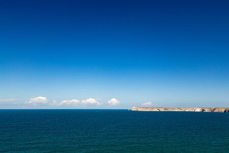 Nice horizontal view on the ocean with cliffs in the background.の写真素材