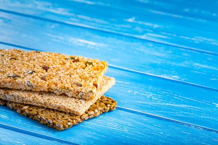 Sesame seeds, sunflower seeds and nuts in caramel glaze on the wooden rustic background.の写真素材