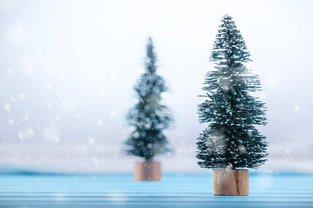 Miniature toy Christmas tree on a wooden table. Imitation realistic scene.の写真素材