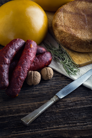 Homemade sheep and cow's cheese from Romania. Sausage, rosemary and chilli.の写真素材