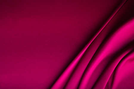 Shiny wine red satin curved in various lines.の写真素材