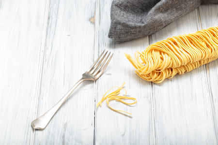 Fresh homemade Italian pasta on a table with forkの写真素材