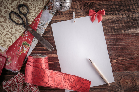 Christmas wish list for Santa. Top-down view on a blank letter on the wooden table.の写真素材