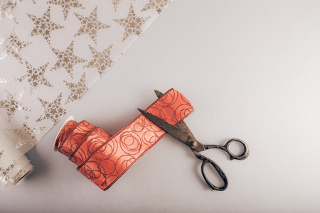 Decorative ribbon and old tailor's scissors. Christmas craft supplies.の写真素材
