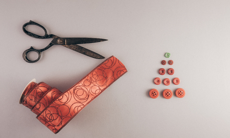 Decorative ribbon and old tailor's scissors. Christmas tree from tailoring buttons.の写真素材