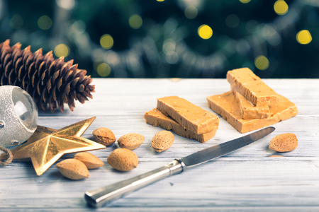 TurrÃ³n is a traditional Spanish sweets. Decorations of almonds and beautiful bokeh.の写真素材
