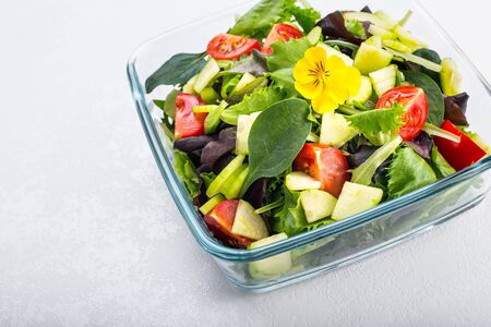 Bowl of vegetable salad with edible flowers.の写真素材