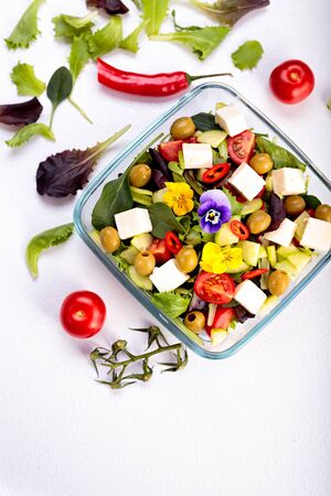 Bowl of vegetable salad with edible flowers. Top view.の写真素材