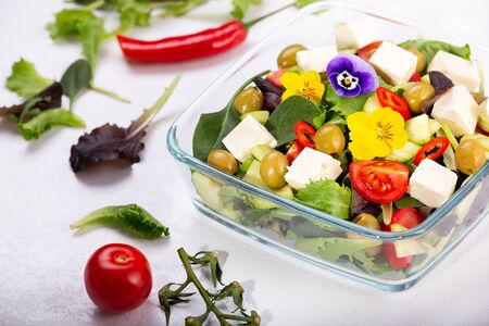 Bowl of vegetable salad with edible flowers.の写真素材