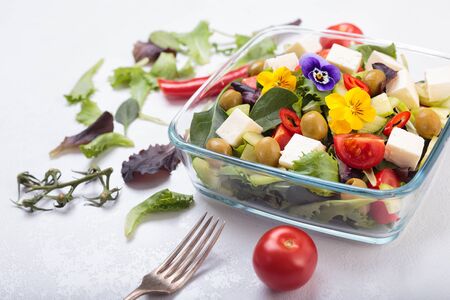 Bowl of vegetable salad with edible flowers.の写真素材