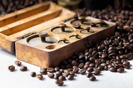 Old rustic metal weights with roasted coffee beans.の写真素材