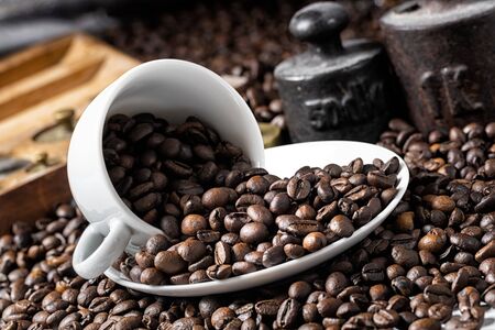 White coffee cup and roasted coffee beans with rustic weightの写真素材