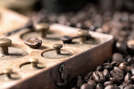 Old rustic metal weights with roasted coffee beans.の写真素材