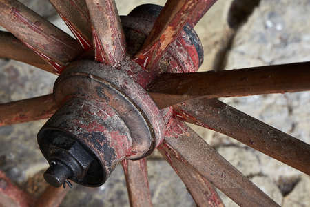 Close-up of an old wooden wheel on a rustic wooden wagonの写真素材