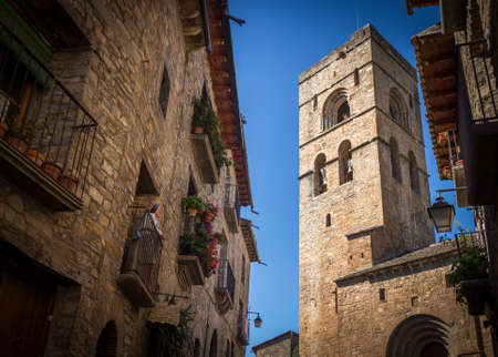 Ainsa, Spain - September 11 2017: Statue of an old woman looking at the church bell tower from the balcony in a village in Spainのeditorial素材