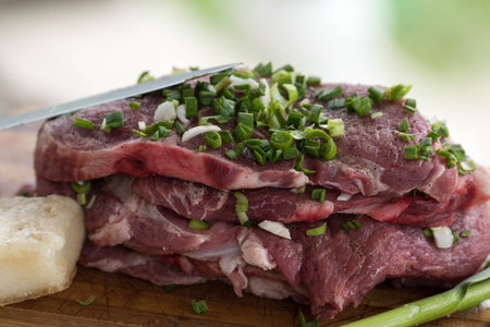 Pork meat with green garlik ready to be grilledの写真素材