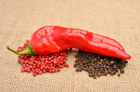 Hot chili and peppers on old canvas
