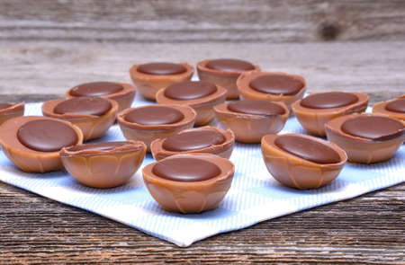 Chocolate candies on old wooden tableの写真素材
