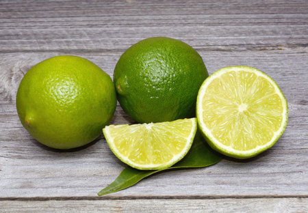 Fresh limes on wooden background