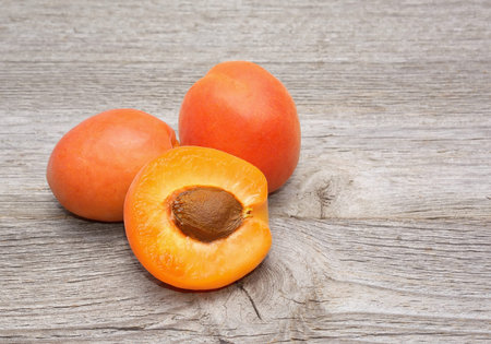 Fresh apricots on wooden background