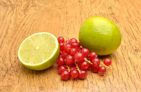 Red currant and lemons on wooden backgroundの写真素材