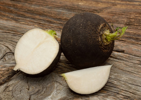 Black radish on wooden backgroundの写真素材