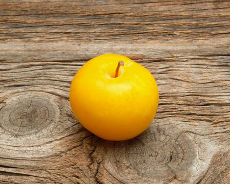 yellow plum wooden backgroundの写真素材
