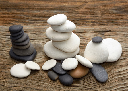 Stack of zen stones over wooden background