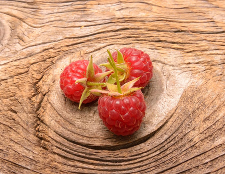 Ripe fresh raspberries on a wooden backgroundの写真素材