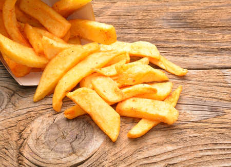 fried potatoes on a wooden backgroundの写真素材