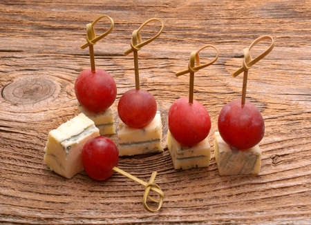 pieces of blue cheese and red grapesの写真素材