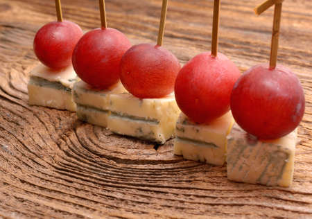 pieces of blue cheese and red grapesの写真素材